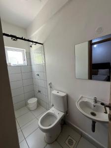 a bathroom with a toilet and a sink at Buxton Point Kandy Cozy Two Bedroom Apartment in Mombasa