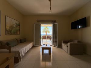 a living room with a couch and a table at Kefalonian Oneira Villas in Mousata