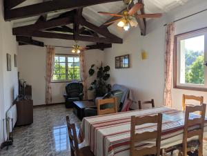 a living room with a ceiling fan and a table at villa relax in Ascain +11 photos