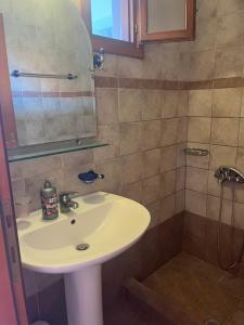 a bathroom with a sink and a shower at Hotel Kosmas in Sarti
