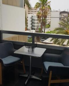 a table and two chairs in front of a window at Il Ducale a Playa del Inglés in Playa del Ingles