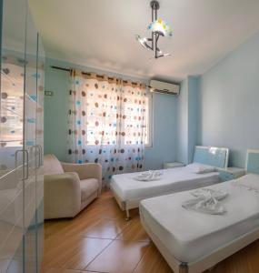 a hospital room with two beds and a couch at Paris Luxury Penthouse in Sarandë
