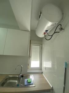 a small kitchen with a sink and a window at Beachside Getaway in Zapillo in Almería +11 photos