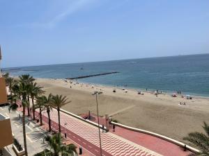 a beach with a bunch of people and the ocean at Beachside Getaway in Zapillo in Almería