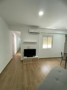 an empty living room with a flat screen tv at Beachside Getaway in Zapillo in Almería