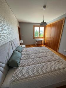 a large bed in a bedroom with a window at House Infantado Loures in Loures