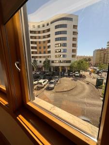 a window with a view of a parking lot at House Infantado Loures in Loures
