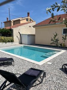 a swimming pool in the backyard of a house at Manolo house with jacuzzi & pool in Pula