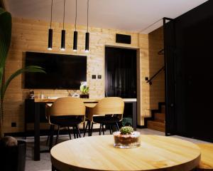 a dining room with a table and chairs at "STAVA" domy wypoczynkowe in Stara Kiszewa