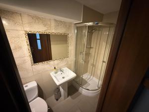 a bathroom with a toilet and a sink and a shower at Pod Różą in Rząska +25 photos