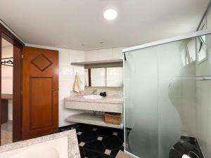 a bathroom with a shower and a sink at RG01- 3 Suítes| Pé na Areia| Vista Mar| Churrasq in Balneário Camboriú +52 photos