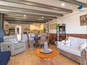a living room with two couches and a table at The Old Fisherman House in Cala Figuera