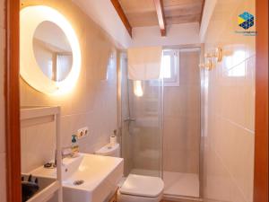 a bathroom with a shower and a toilet and a sink at The Old Fisherman House in Cala Figuera