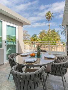 a dining room with a table and chairs at AQUA Terrazas Studio 7 - Beachfront Getaway with King Bed & Pool in Dorado