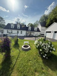a yard with a fire pit in the grass at Cute 6-Bedroom Getaway in the heart of Littleton in Littleton