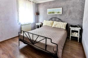 a bedroom with a bed and a window at La Maison du Mazet in Maillane
