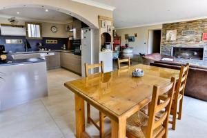 a kitchen and living room with a wooden table at La Maison du Mazet in Maillane