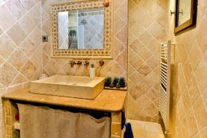 a bathroom with a sink and a mirror at La Maison du Mazet in Maillane +8 photos