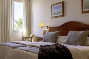 Ένα ή περισσότερα κρεβάτια σε δωμάτιο στο Hotel Restaurante Emilio