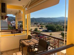 a balcony with a table and chairs and a view at Hotel Kosmas in Sarti