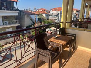 a balcony with a table and chairs on a balcony at Hotel Kosmas in Sarti