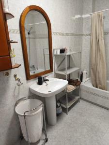 a bathroom with a sink and a mirror and a tub at CA ÁNGEL in Anna +36 photos