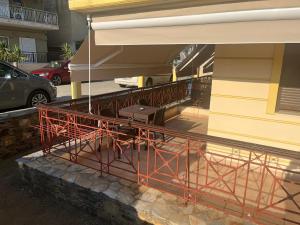 a building with a metal railing next to a building at Hotel Kosmas in Sarti