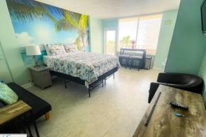 a bedroom with a bed and a table in it at Stylish Studio Ocean View in Daytona Beach +18 photos