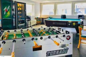 a room with a pool table and a game room at Stylish Studio Ocean View in Daytona Beach