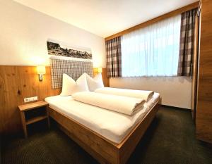 Una cama o camas en una habitación de Apart Stella Alpina