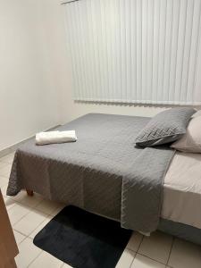 a large bed in a room with a large window at Cozy y Quiet House with Private Garden in Cochabamba +10 photos