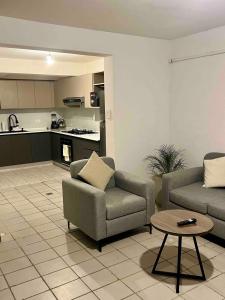 a living room with two couches and a table at Cozy y Quiet House with Private Garden in Cochabamba