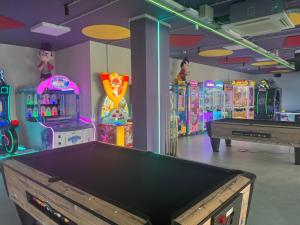 a room with a pool table and many arcade machines at Taurito Bay in Taurito