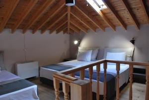 a bedroom with two beds and a wooden ceiling at Troyan Hill Apartments in Petra +31 photos