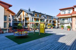 a playground in front of a apartment building at Bears Apartments in Palanga