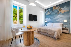 a bedroom with a bed and a table at Rebirth apartments in Dubrovnik
