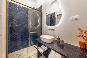 a bathroom with a sink and a glass shower at Rebirth apartments in Dubrovnik +61 photos