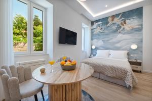 a bedroom with a bed and a table with a bowl of fruit on it at Rebirth apartments in Dubrovnik