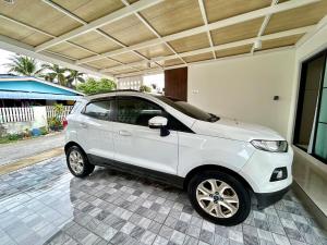 a small white car parked in a garage at Home 2 bedroom Rayong long stay Phala Beach in Ban Chang