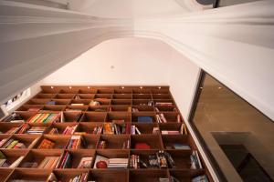 an attic room with a staircase filled with books at Hopper Hotel St. Josef, WorldHotels Crafted in Cologne