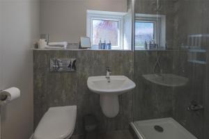 a bathroom with a sink and a toilet at The Crooklands, BW Signature Collection in Crooklands