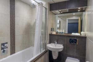 a bathroom with a sink and a toilet and a shower at The Crooklands, BW Signature Collection in Crooklands