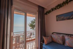 a room with a bed and a window with a view at Seagull House by RentalsPro - Nea Potidaia Hlkidiki in Nea Potidaea +20 photos