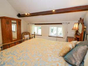 En eller flere senge i et værelse på Fern Cottage