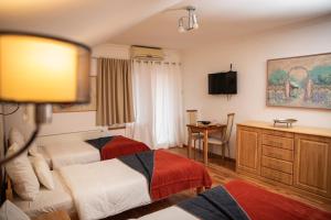 a hotel room with two beds and a desk at Apartments 135 in Vršac