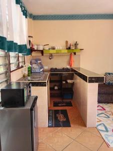 a kitchen with a counter and a refrigerator at milina homes in Ukunda +2 photos