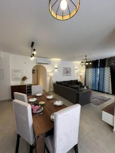 een eetkamer en woonkamer met een tafel en stoelen bij prime homes in Banī Ghālib