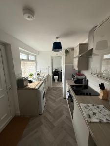 a kitchen with a sink and a stove top oven at Spacious 4Bed - Next to Stadium in Sunderland