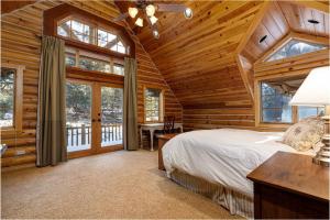 une chambre avec un lit dans une cabane en rondins dans l'établissement Mammoth Creek Luxury Retreat near Zion and Bryce C, à Panguitch
