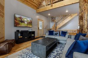 a living room with a couch and a table at Aspen Glow Brand New Hot Tub in Duck Creek Village